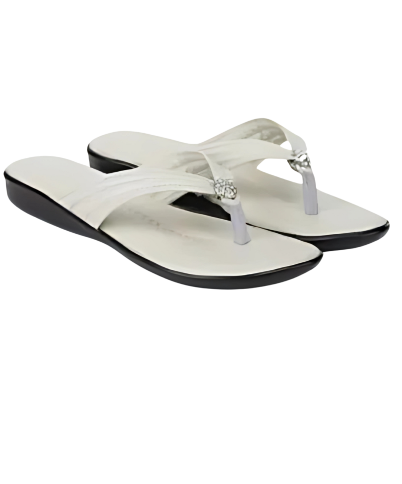 A pair of elegant white and black wedge flip-flops with a stylish toe strap adorned with a decorative silver embellishment. These comfortable and fashionable sandals are perfect for casual and semi-formal occasions.