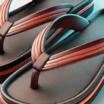 A pair of premium-quality flip-flops with a stylish dual-tone brown and orange design. Featuring a cushioned sole and durable straps for maximum comfort and long-lasting wear.